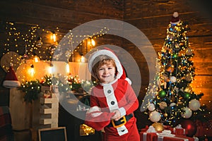 Little Santa Claus helper elf with a magic gift for Christmas. Christmas shopping concept. Gifts service. Little genius