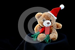 Little Santa Claus plush toy isolated on black background