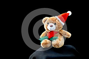 Little Santa Claus plush toy isolated on black background