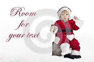 Little santa claus seated on a Christmas in the snow
