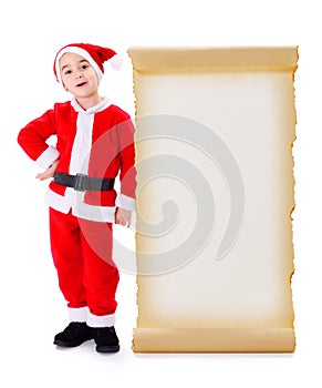 Little Santa Claus standing near big wish list