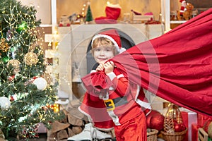 Little Santa huge bag run to delivery christmas gift. Santa helper with a huge bag. Santa helper carrying sack full of