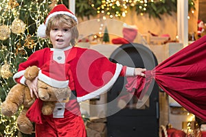 Little Santa huge bag run to delivery christmas gift. Santa helper. Santa helper carrying sack full of gifts. Winter