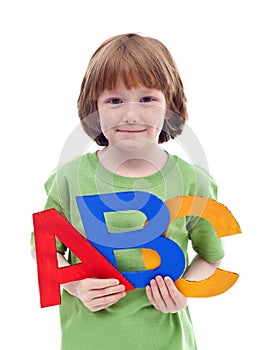 Little school boy with large letters