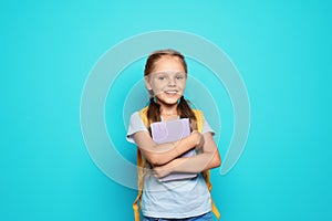 Little school child with backpack and copybook