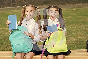 Little school friends girls with backpacks, sincere happiness concept