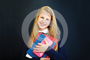 little school girl near school blackboard