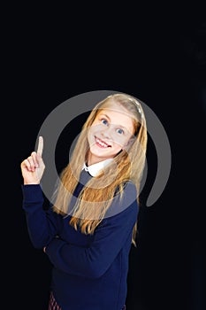 little school girl near school blackboard