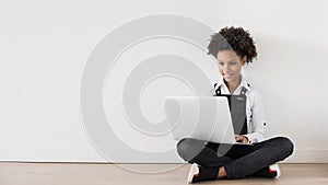 Little school girl using laptop at home panoramic banner, kid learning online