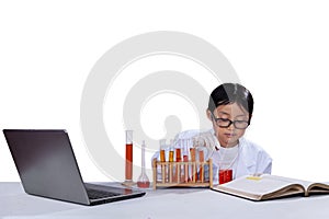 Little schoolboy doing research