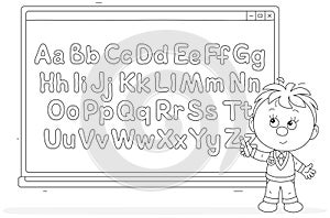 Little schoolboy near a school smart whiteboard