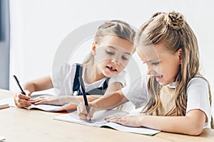 little schoolgirl cheating and copying work of her classmate