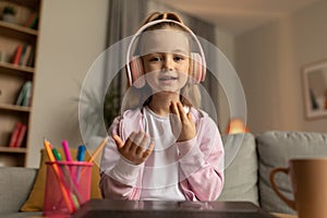 Little Schoolgirl Making Video Call Talking To Laptop At Home