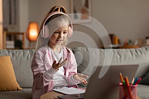 Little Schoolgirl Making Video Call Via Laptop Learning At Home