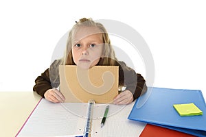 Little schoolgirl sad tired and bored holding paper with blank copy space for adding text