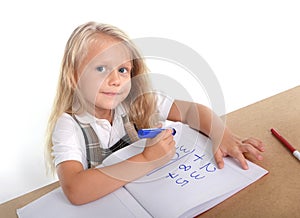 Little schoolgirl sitting happy adding numbers in children education concept
