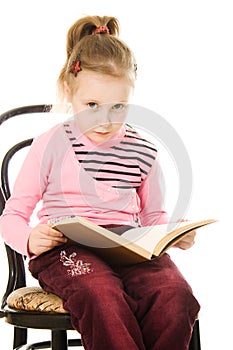 Little serious girl with a book
