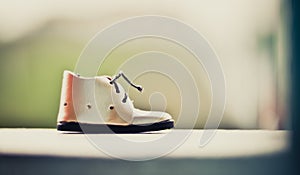 Little Shoes and blur nature background with vintage tone