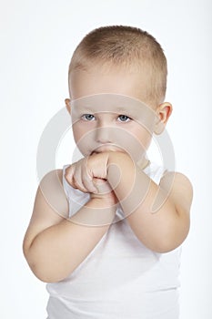 Little shy boy on white background