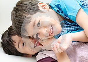 Little sibling boy fighting on sofa