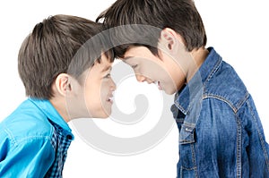 Little sibling boy fighting on white background