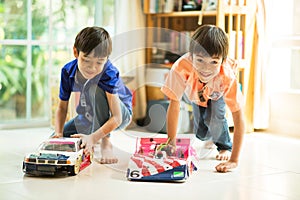 Little sibling boy playing car toy race together