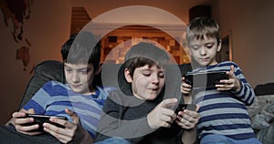 Little sibling boy playing game on mobile together. leisure, children, technology, internet communication and people