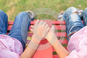 Little sibling boy sitting with hand holding