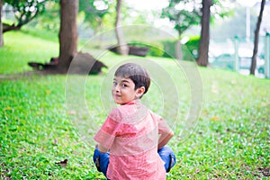 Little sibling boy sitting together in the park outdoor