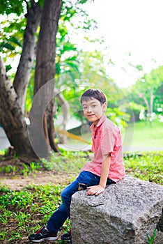 Little sibling boy sitting together in the park outdoor