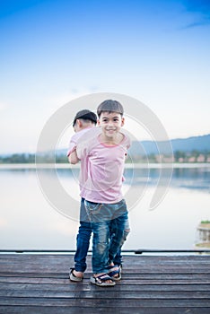 Little sibling boy standing together