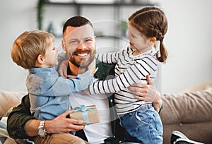 Little siblings congratulating happy father at home