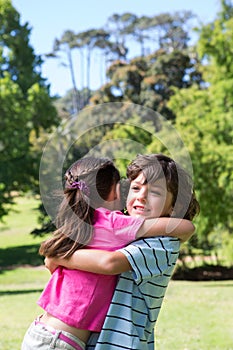 Little siblings hugging each other