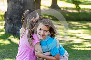 Little siblings smiling at camera