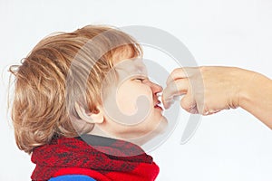 Little sick boy used medical nasal spray in the nose