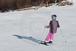 Little skier racing in snow