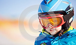 Little skier in safety helmet and goggles