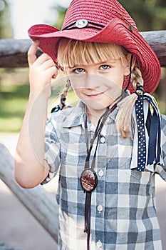 little smile cowboy girl on the ranch