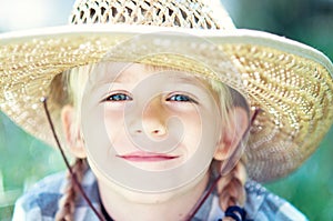 little smile cowboy girl on the ranch