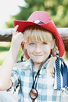 Little smile cowboy girl on the ranch.