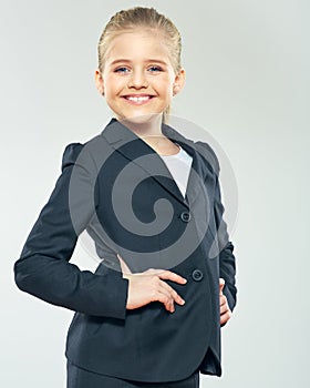 Child girl in business suit. Smiling schoolgirl.