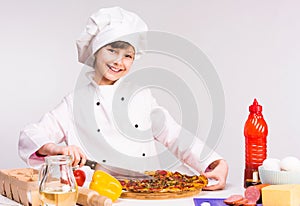 Little smiling girl-cook with big pizza in hands