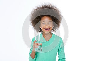 Little smiling girl holding a glass