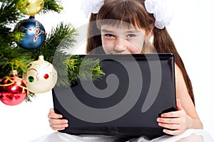 Little smiling girl with laptop computer