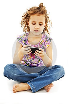 Little smiling girl reading sms on your cell phone