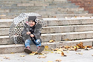 Little smiling girl with umbrella