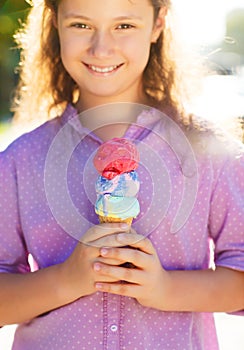 Little smilling girl holding ice cream cone
