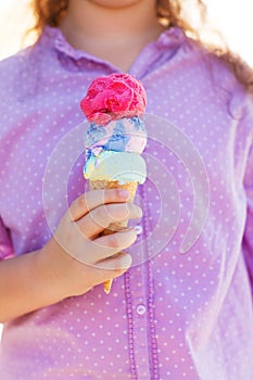 Girl holding ice cream cone in her hands