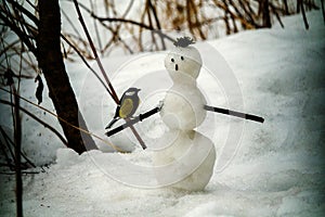 little snowman and a cheerful big tit