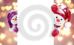 Little snowmen in caps and scarfs on winter background. Background with a funny snowmen. Christmas card.